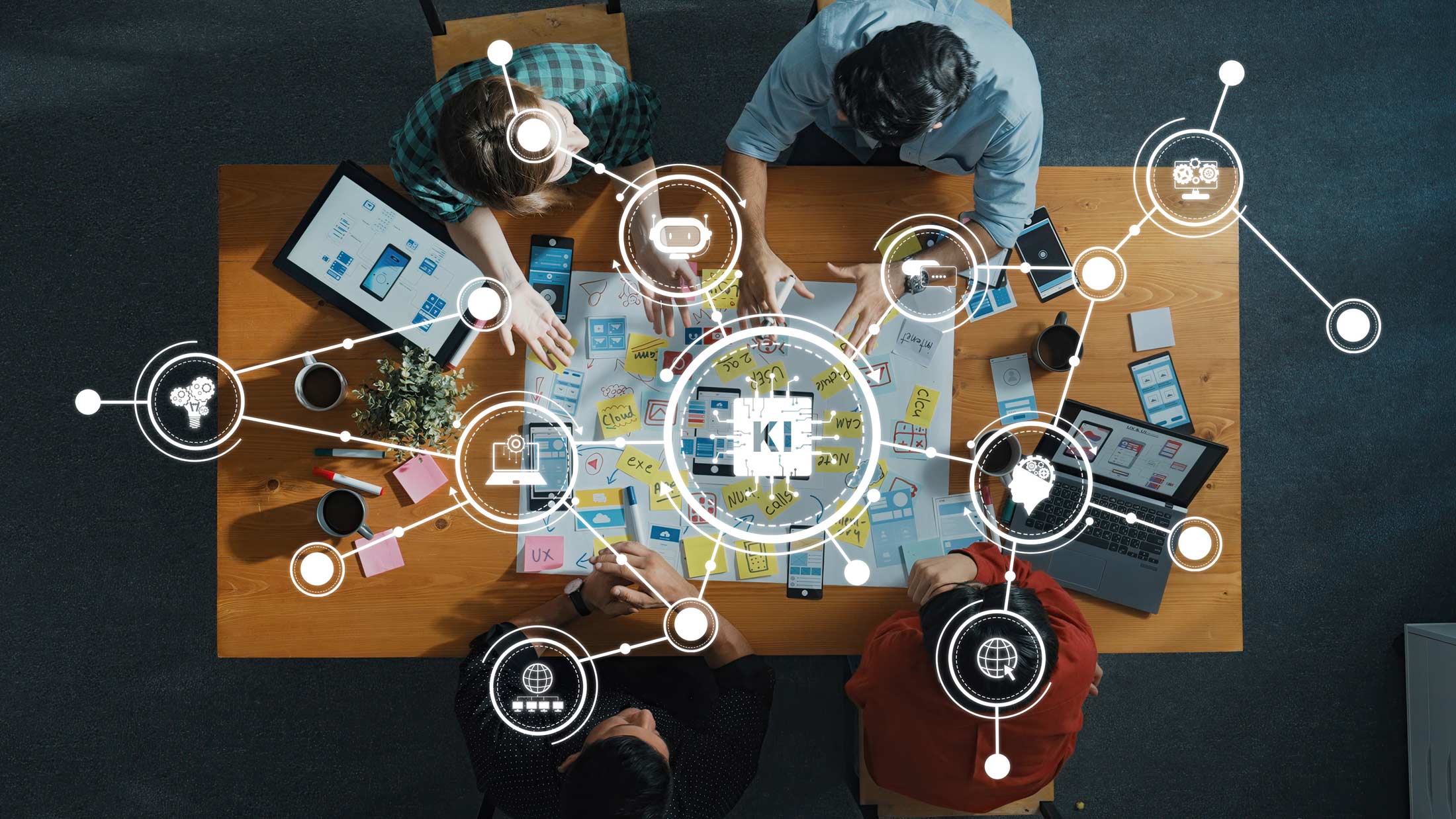 Header KI-Guide: Menschen am Tisch – vernetzt durch ihre technischen Geräte
